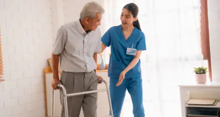 caring nurse assisting elderly